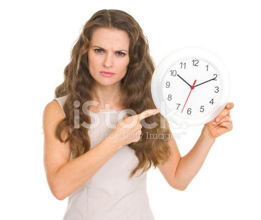 26506664-concerned-young-woman-pointing-on-clock.